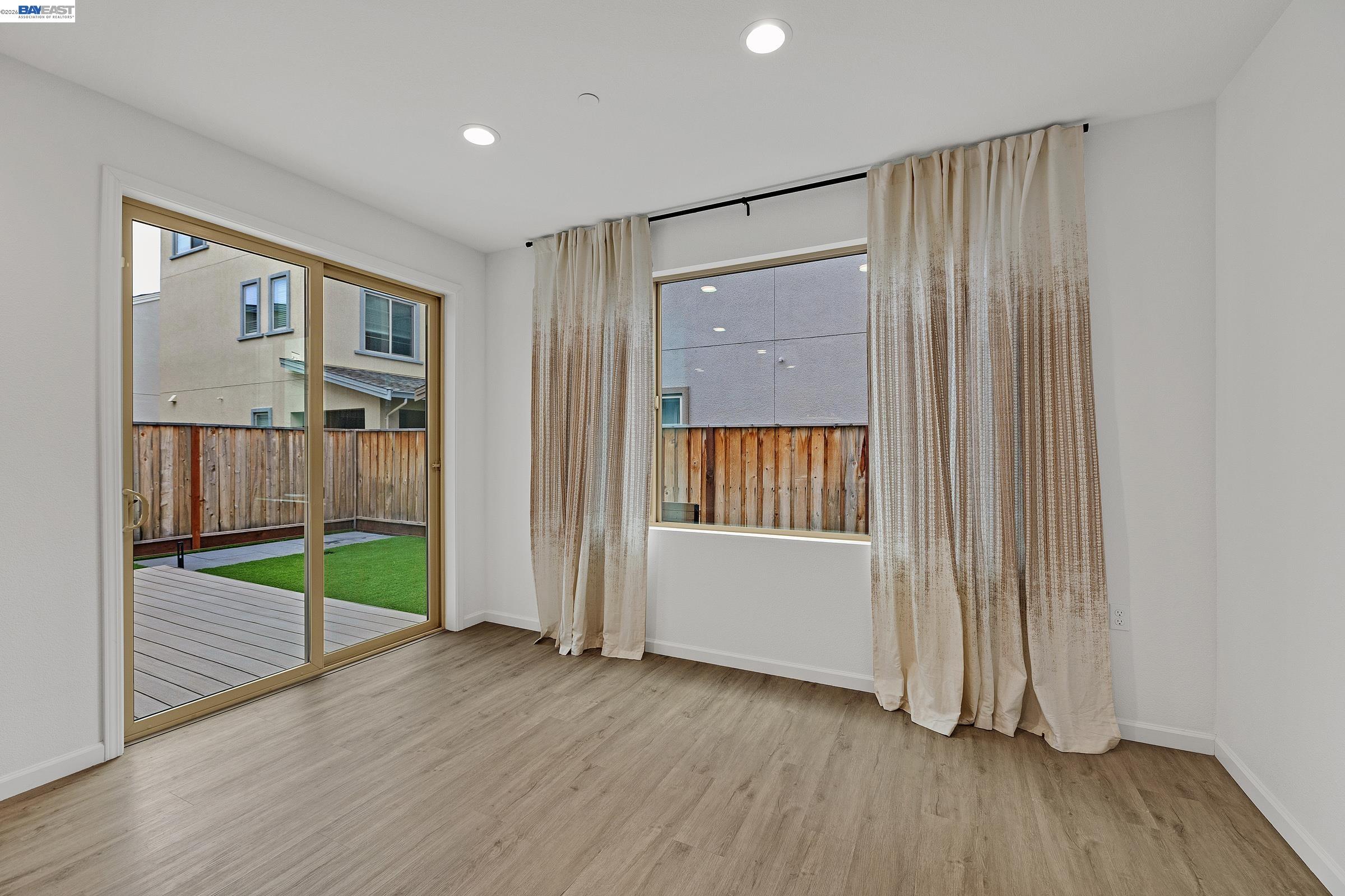 5990 Peridot Place Dublin, CA 94568 - Photo 11 of 43 an empty room with wooden floor and windows
