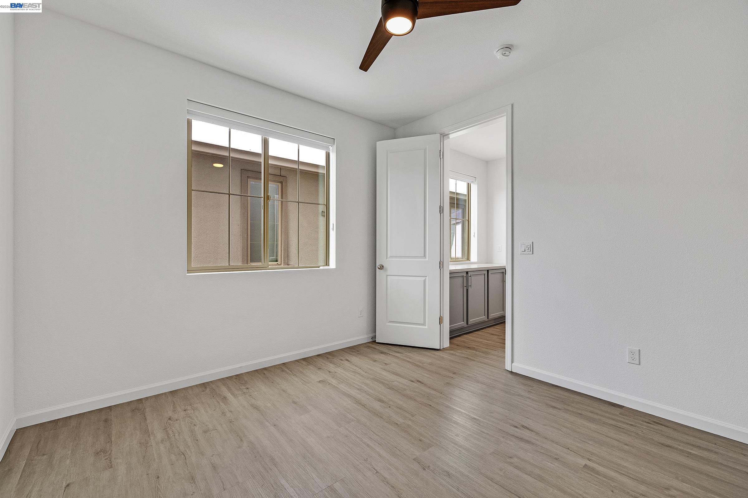 5990 Peridot Place Dublin, CA 94568 - Photo 16 of 43 an empty room with wooden floor and windows