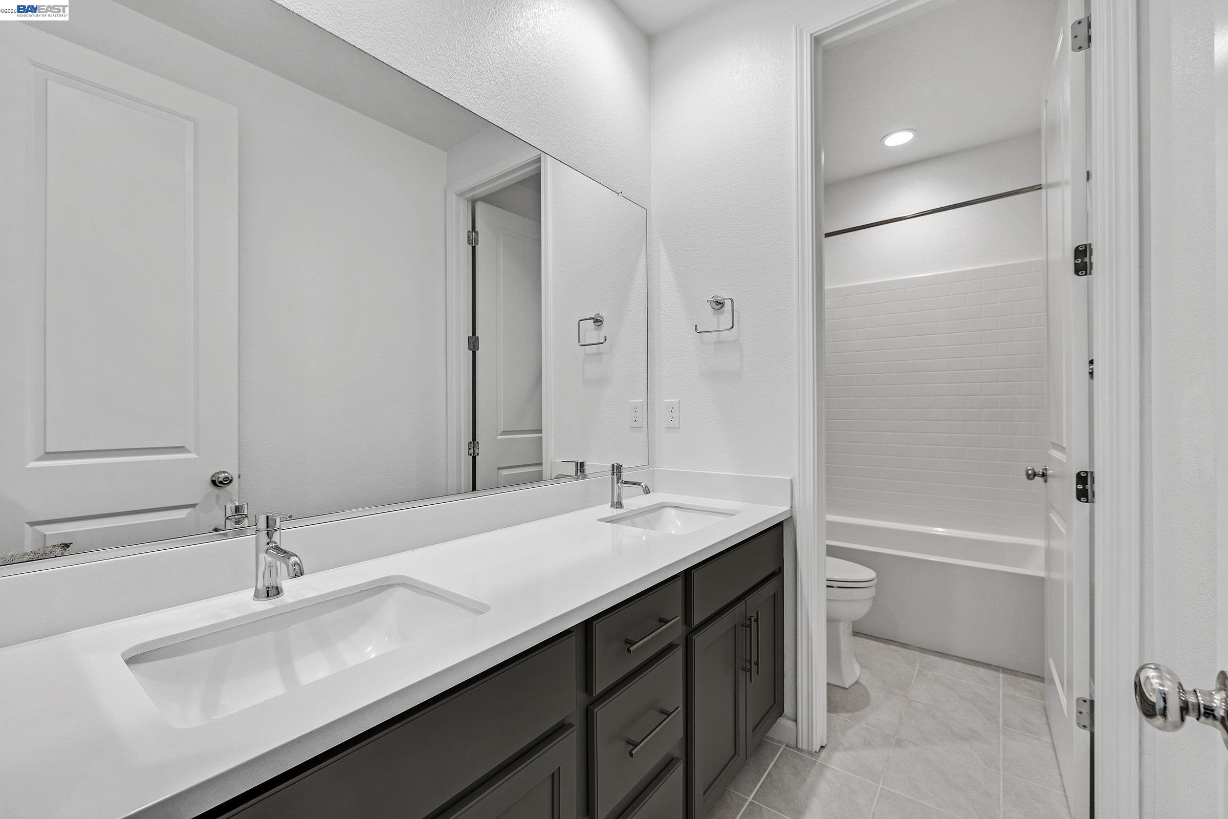 5990 Peridot Place Dublin, CA 94568 - Photo 20 of 43 a bathroom with a sink and a mirror