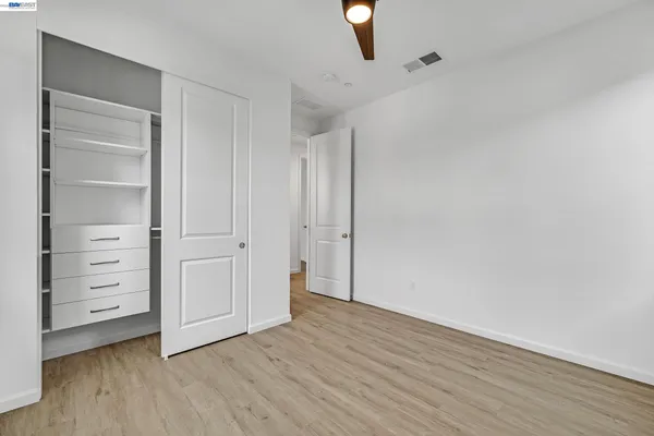 a bedroom with a bed and a television