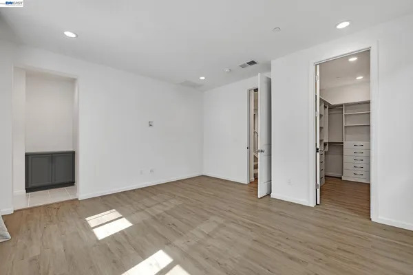 a view of walk in closet with empty racks