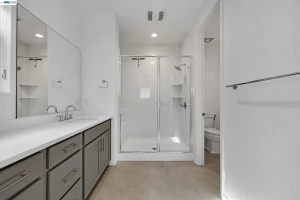 a bathroom with double sink and a mirror