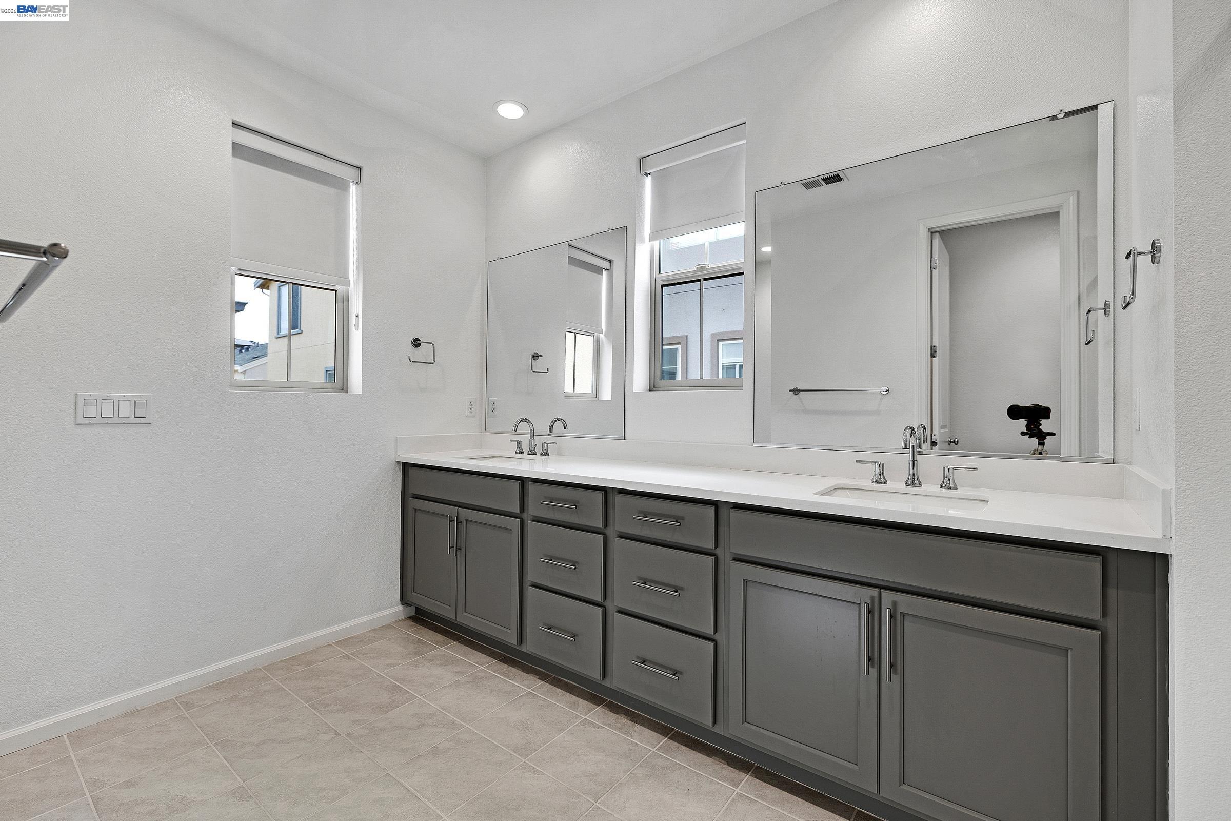 5990 Peridot Place Dublin, CA 94568 - Photo 28 of 43 a bathroom with double sink and a mirror