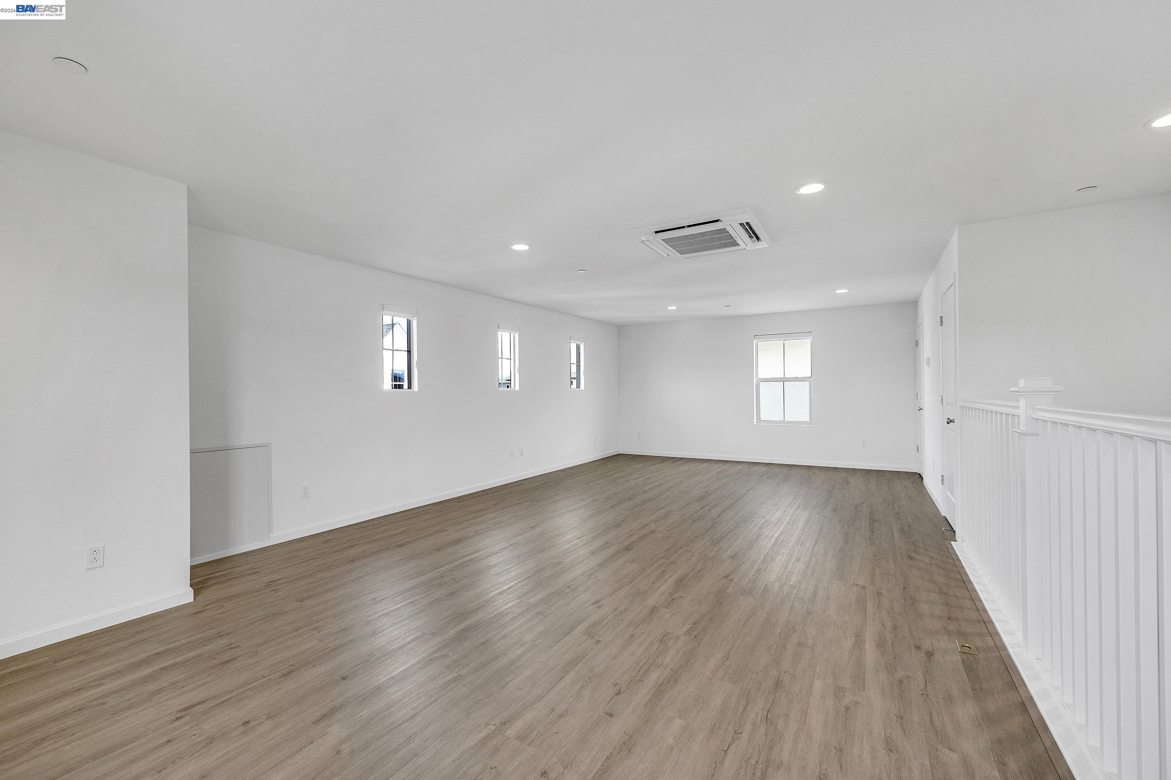 5990 Peridot Place Dublin, CA 94568 - Photo 31 of 43 an empty room with wooden floor and windows