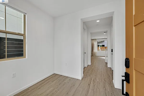 wooden floor in an empty room with a window