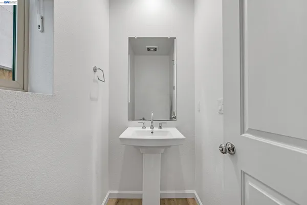 a kitchen with stainless steel appliances a stove a sink a kitchen island with chairs and wooden floor