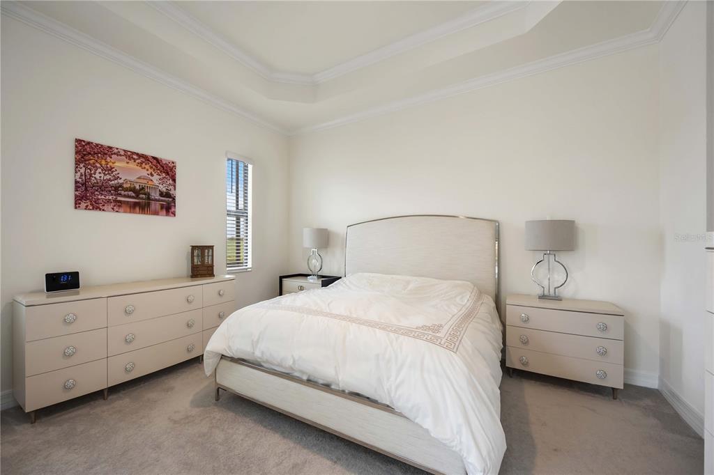 5931 Brandon Run Bradenton, FL 34211 - Photo 18 of 42 a bedroom with a bed and a night stand