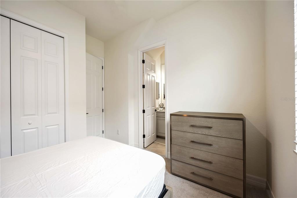 5931 Brandon Run Bradenton, FL 34211 - Photo 21 of 42 a bedroom with a bed and a dresser