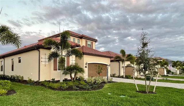 a front view of house with a garden