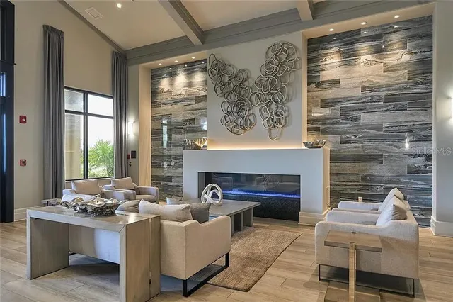 a living room with furniture large window and fireplace