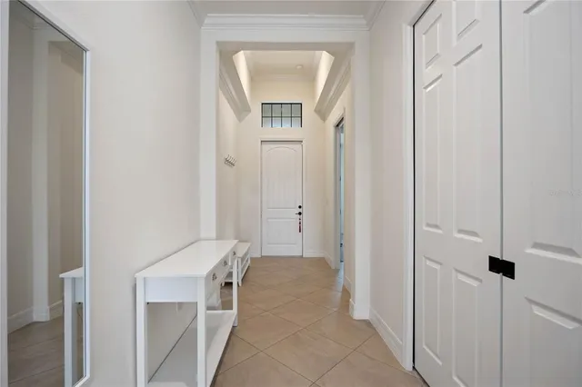 a view of a hallway with closet and a mirror