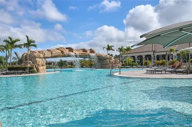 a swimming pool view with a outdoor seating