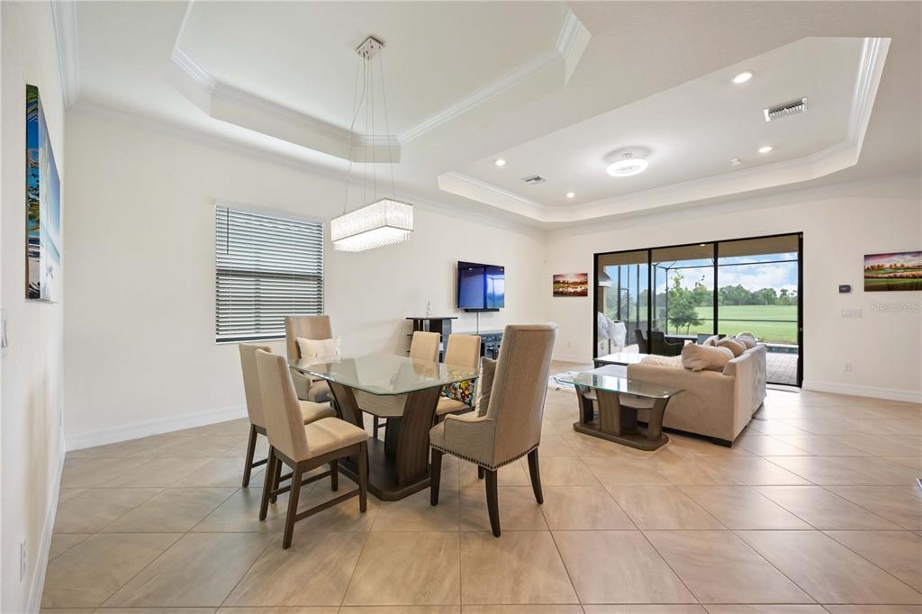 5931 Brandon Run Bradenton, FL 34211 - Photo 7 of 42 a view of a dining room with furniture and a large window