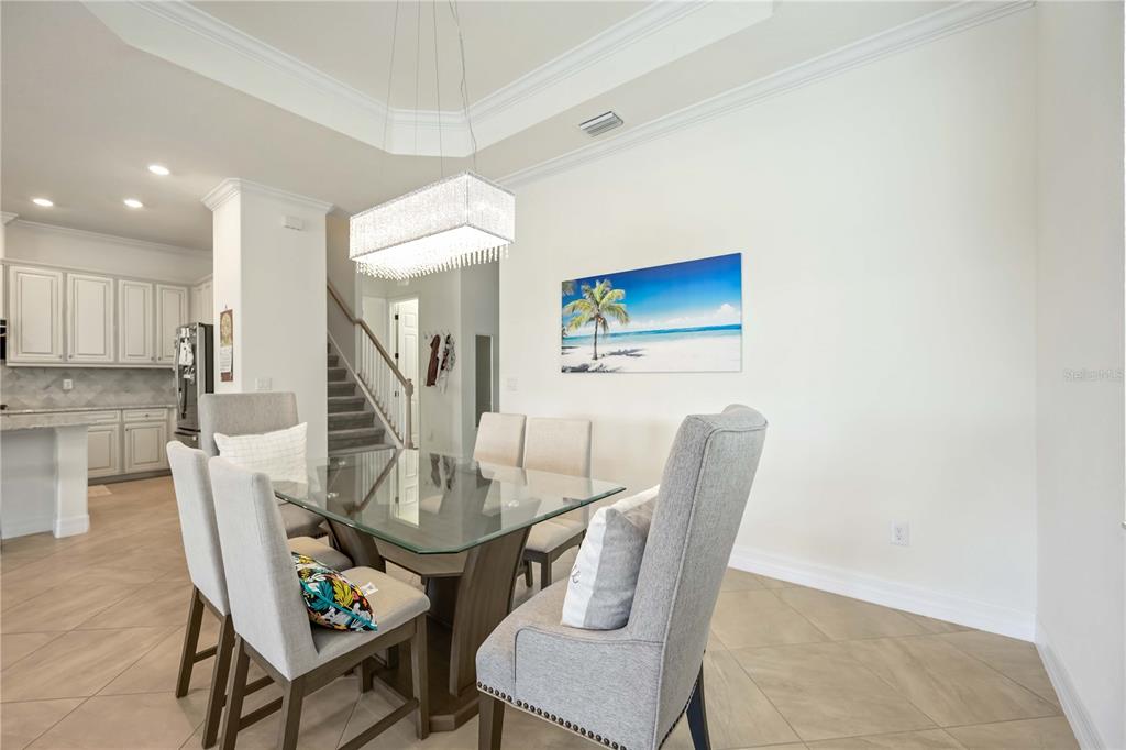 5931 Brandon Run Bradenton, FL 34211 - Photo 9 of 42 a view of a dining room with furniture and wooden floor