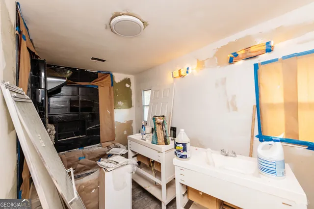 a bedroom with a bed a desk and chair