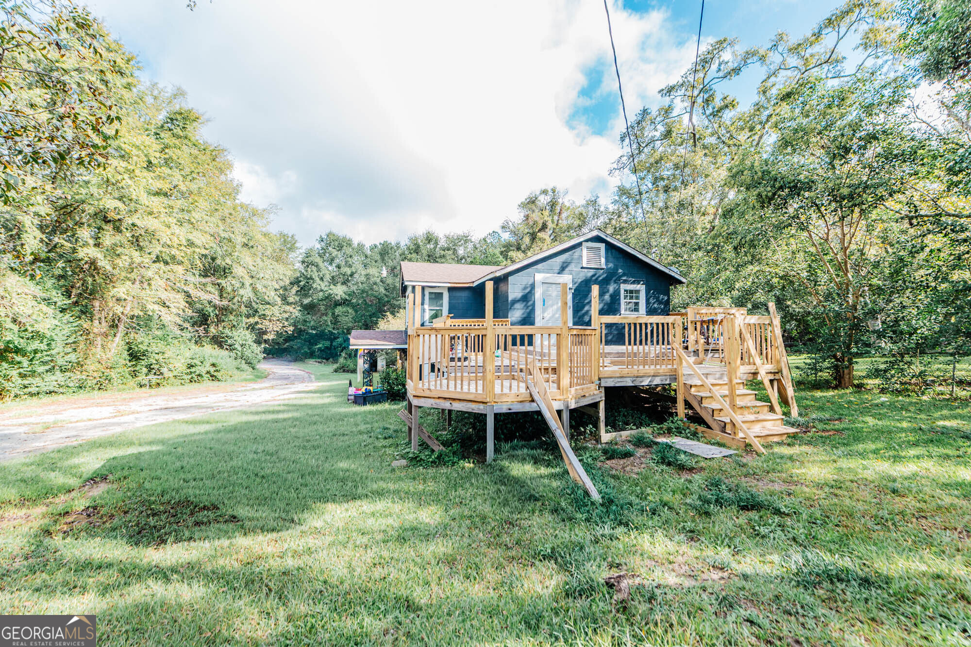 3706 Riggins Mill Road Macon, GA 31217 - Photo 2 of 30 a front view of a house with a yard and deck