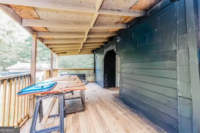 a roof deck with wooden floor and fence