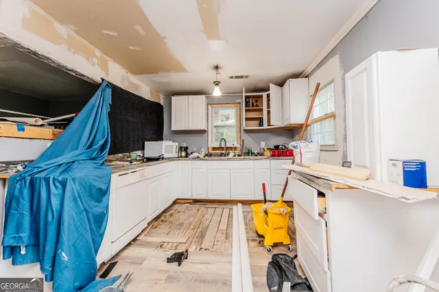 a kitchen with stainless steel appliances kitchen island granite countertop a sink and cabinets