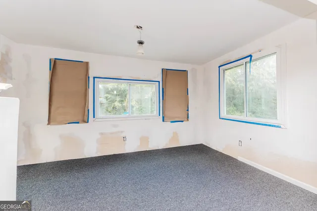a view of an empty room with windows