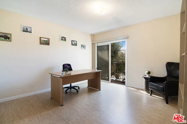 a living room with a couch and potted plants