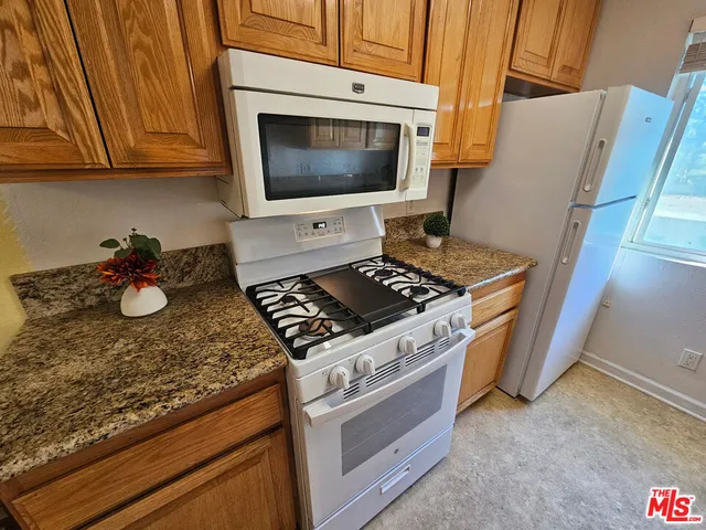 a spacious bedroom with a bed and a large window