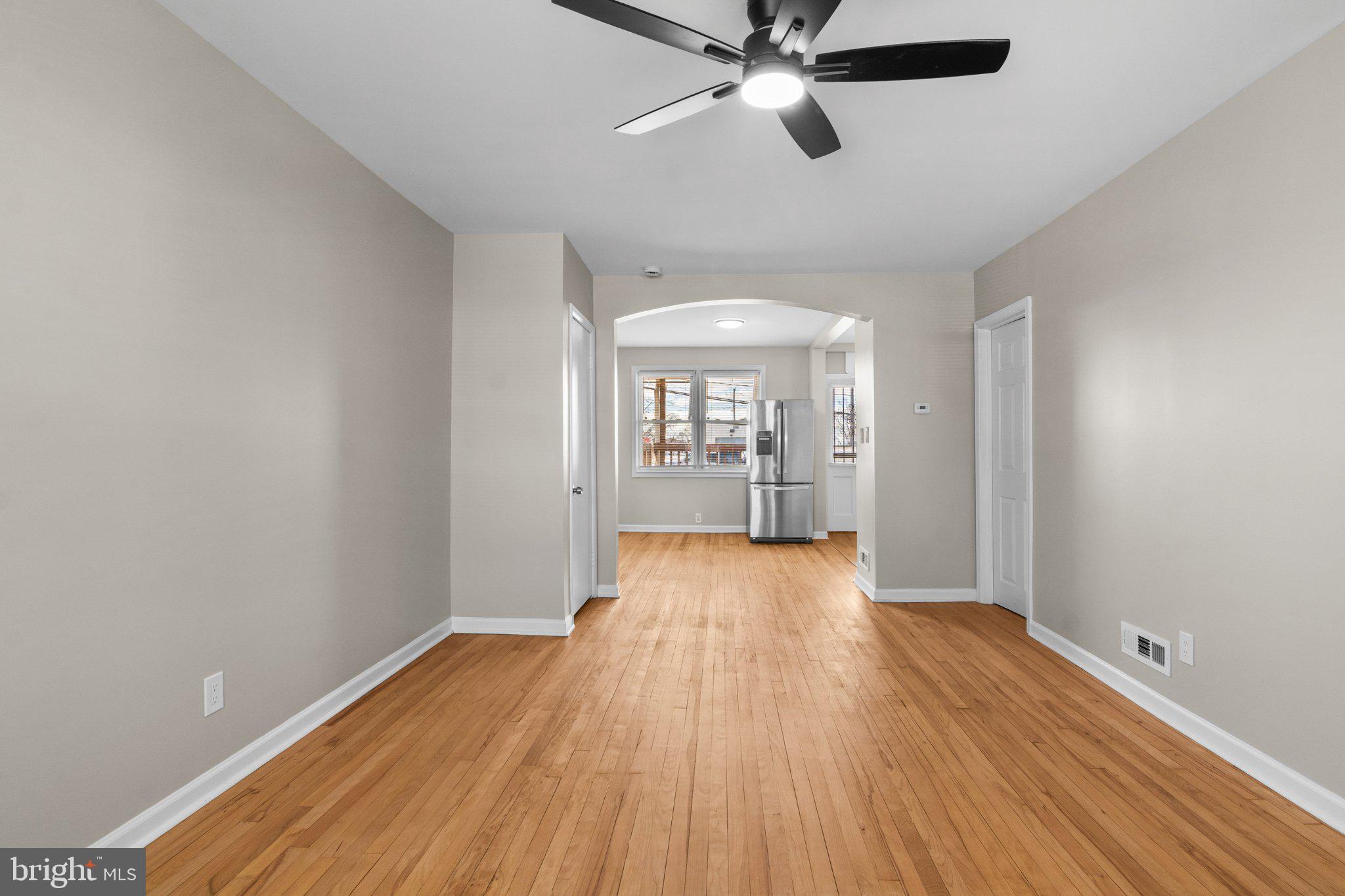 6929 Bank Street Baltimore, MD 21224 - Photo 11 of 30 a view of an empty room with wooden floor and a window