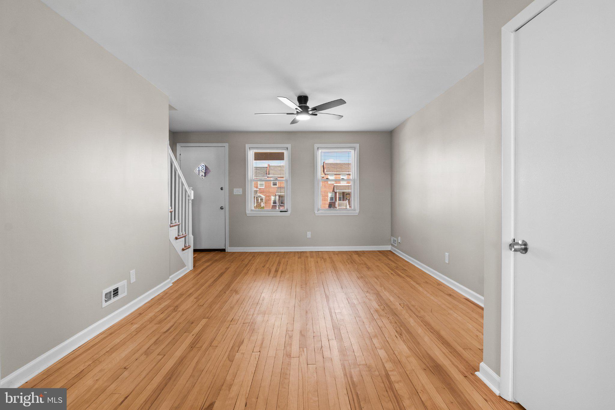 6929 Bank Street Baltimore, MD 21224 - Photo 13 of 30 an empty room with wooden floor and windows