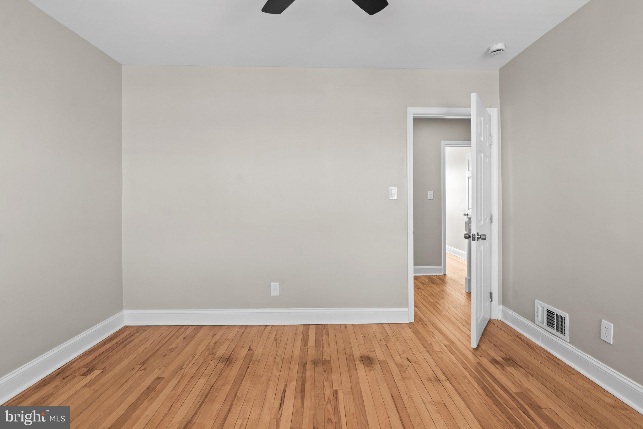 6929 Bank Street Baltimore, MD 21224 - Photo 15 of 30 a view of a room with wooden floor and white walls