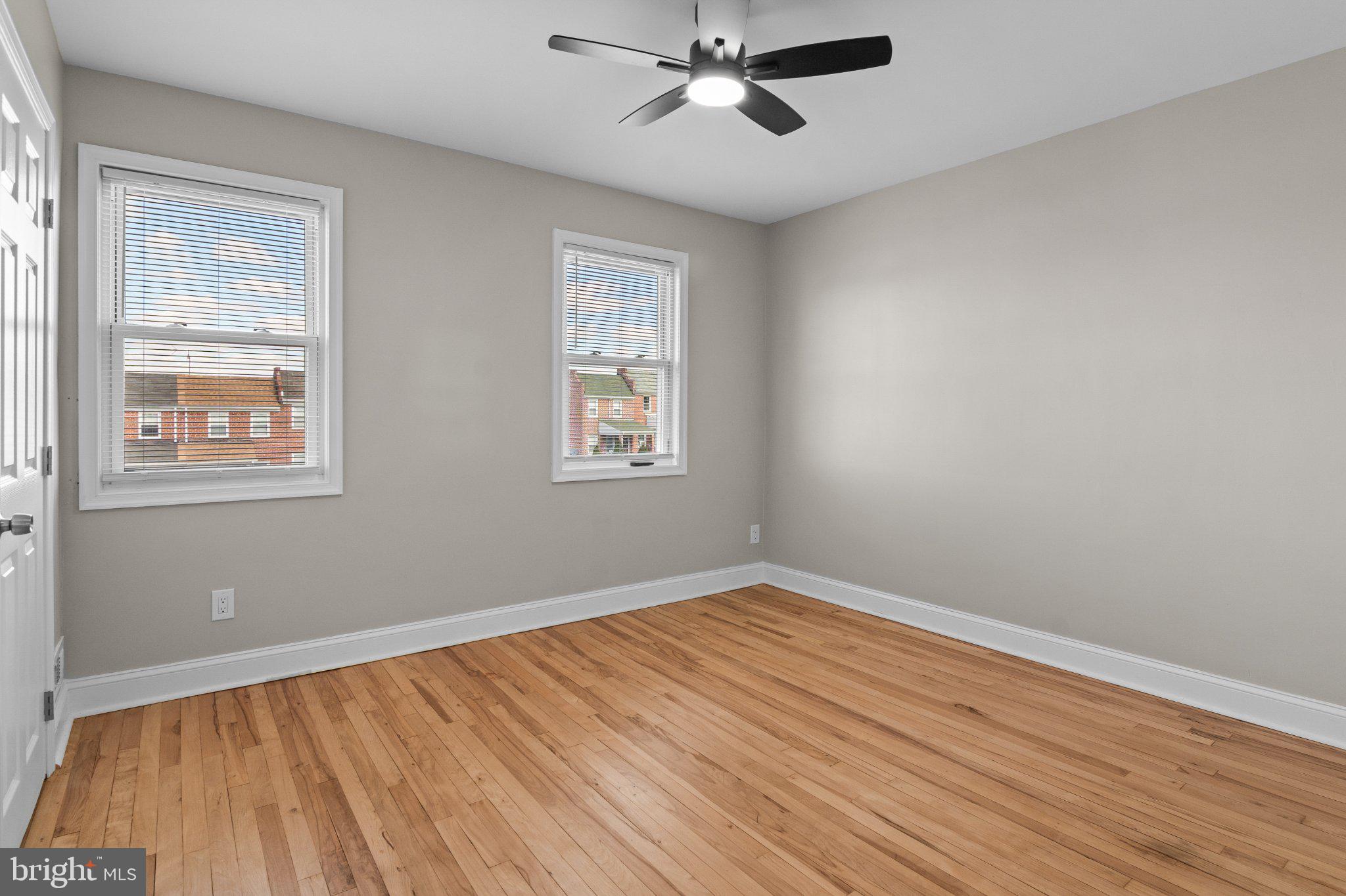 6929 Bank Street Baltimore, MD 21224 - Photo 16 of 30 a view of an empty room with wooden floor and a window