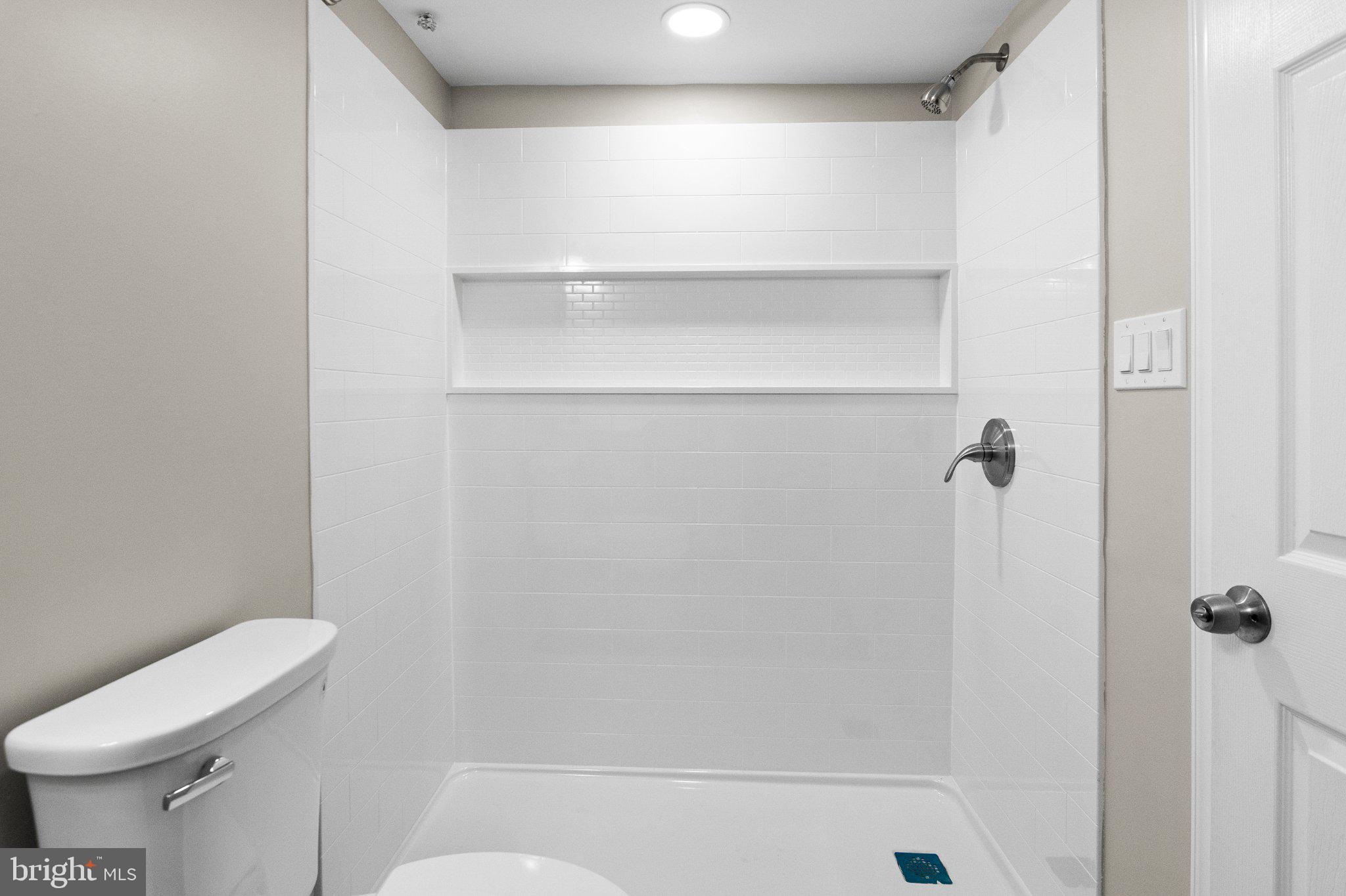 6929 Bank Street Baltimore, MD 21224 - Photo 18 of 30 a bathroom with a shower a toilet and a sink
