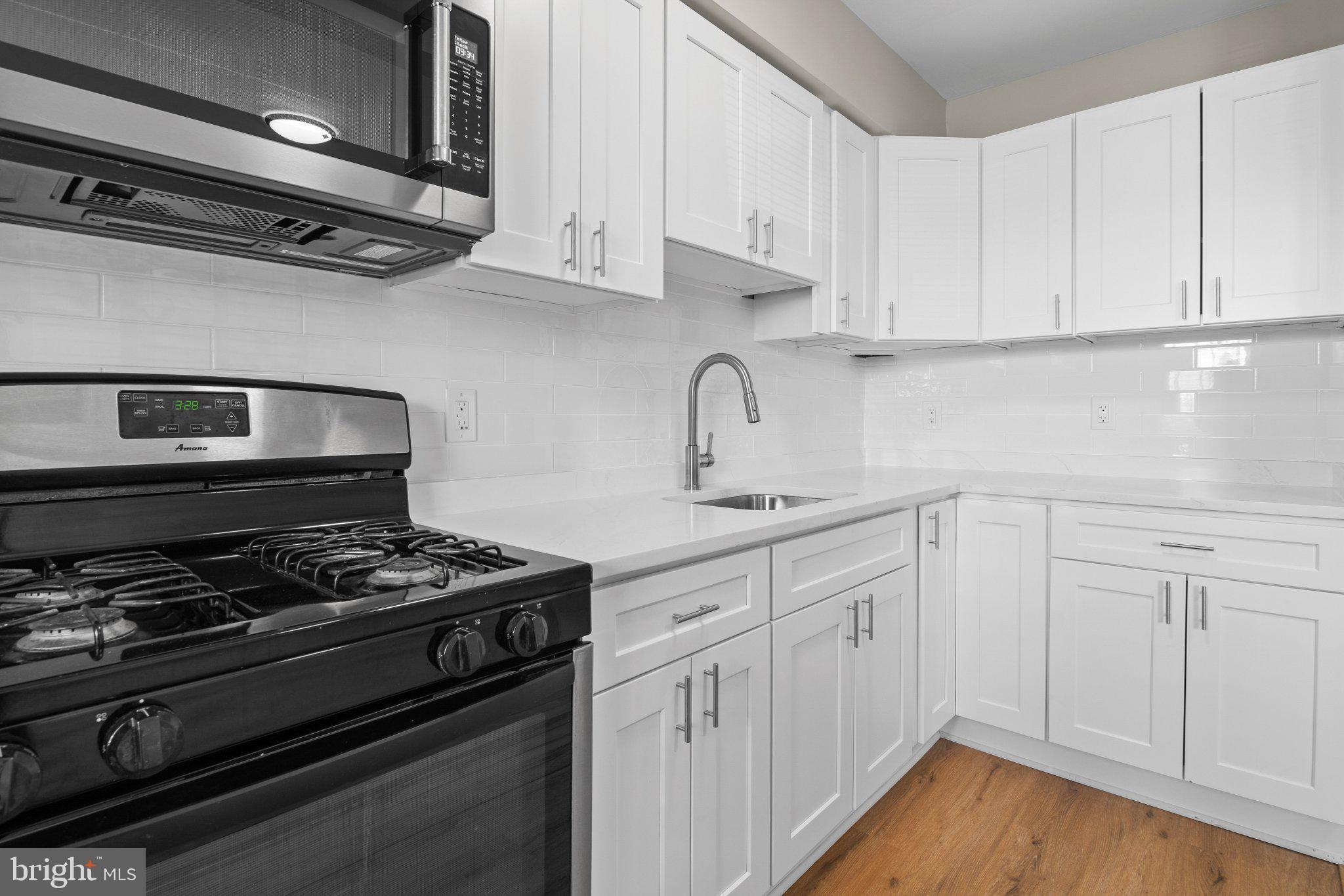6929 Bank Street Baltimore, MD 21224 - Photo 4 of 30 a kitchen with white cabinets and appliances
