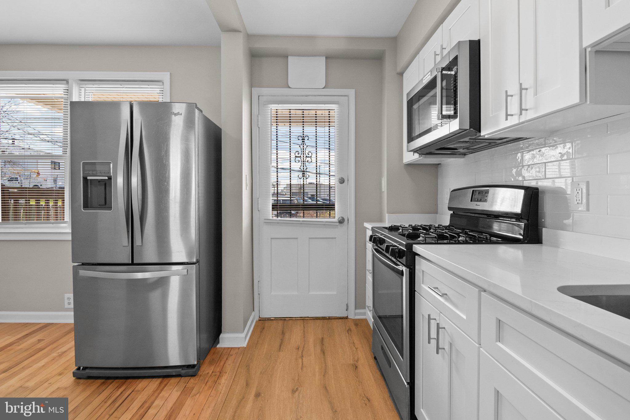 6929 Bank Street Baltimore, MD 21224 - Photo 5 of 30 a kitchen with a refrigerator stove and microwave