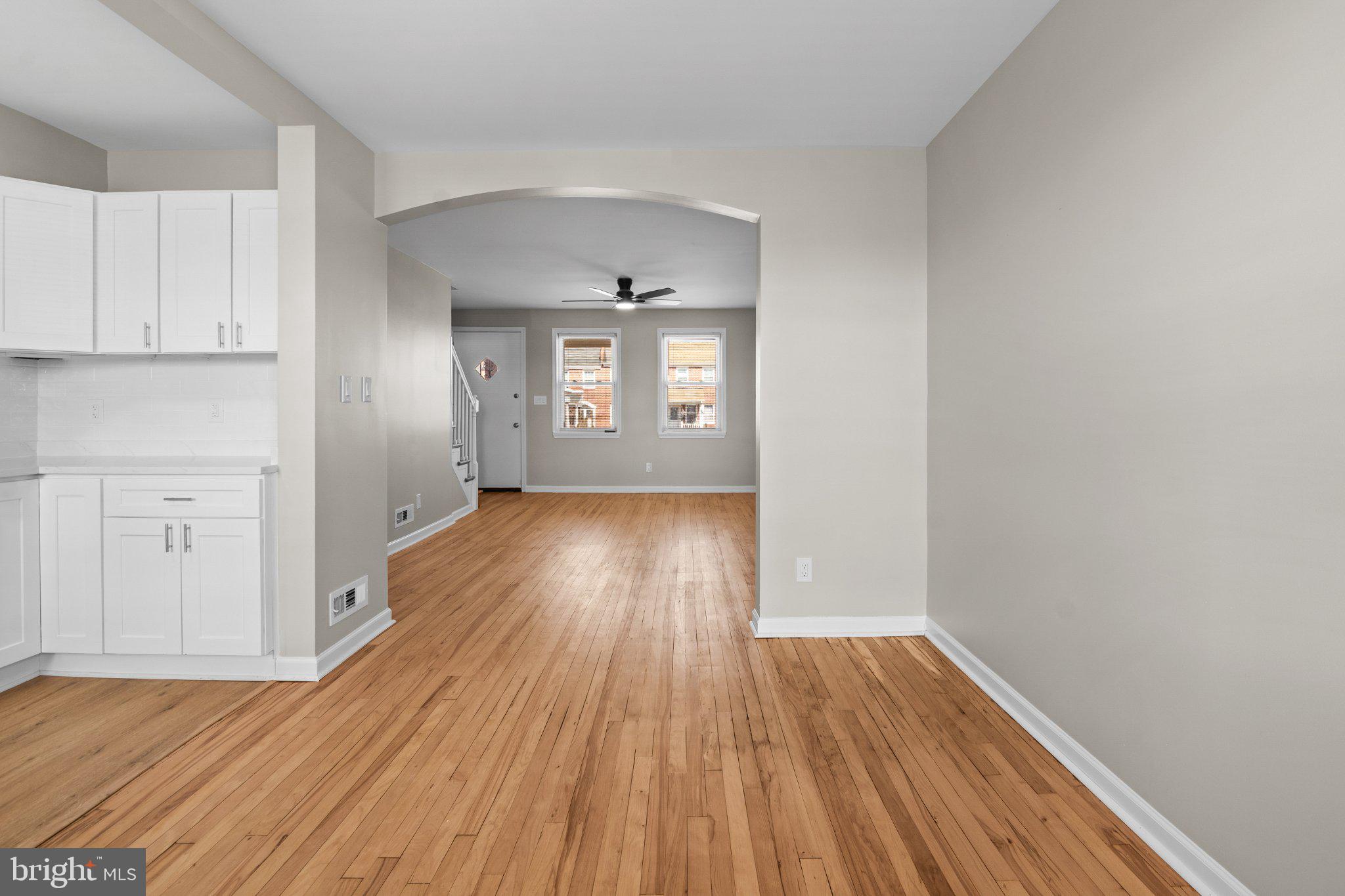 6929 Bank Street Baltimore, MD 21224 - Photo 9 of 30 wooden floor in an empty room with a window