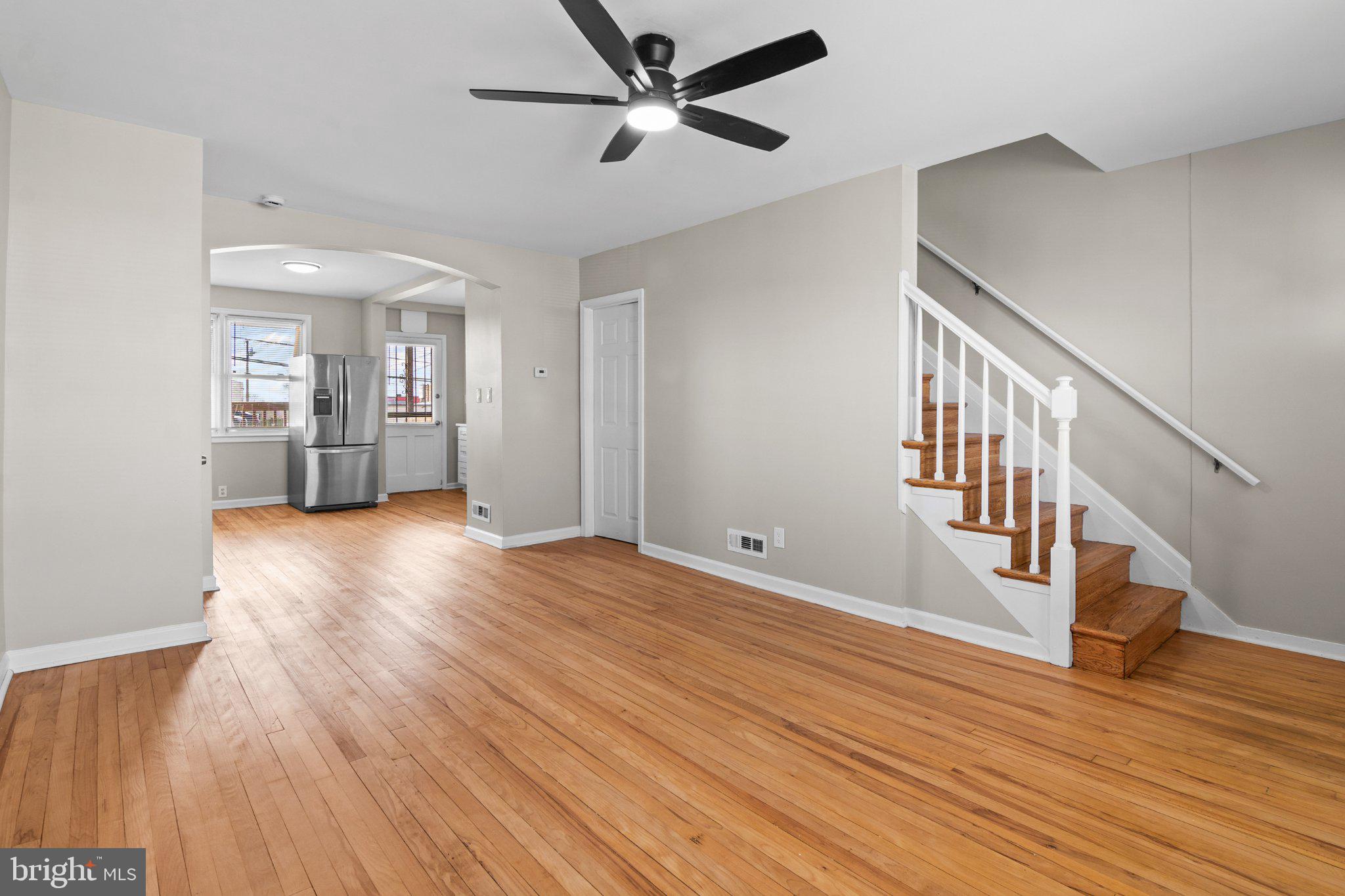 6929 Bank Street Baltimore, MD 21224 - Photo 10 of 30 a view of an empty room with wooden floor and a ceiling fan