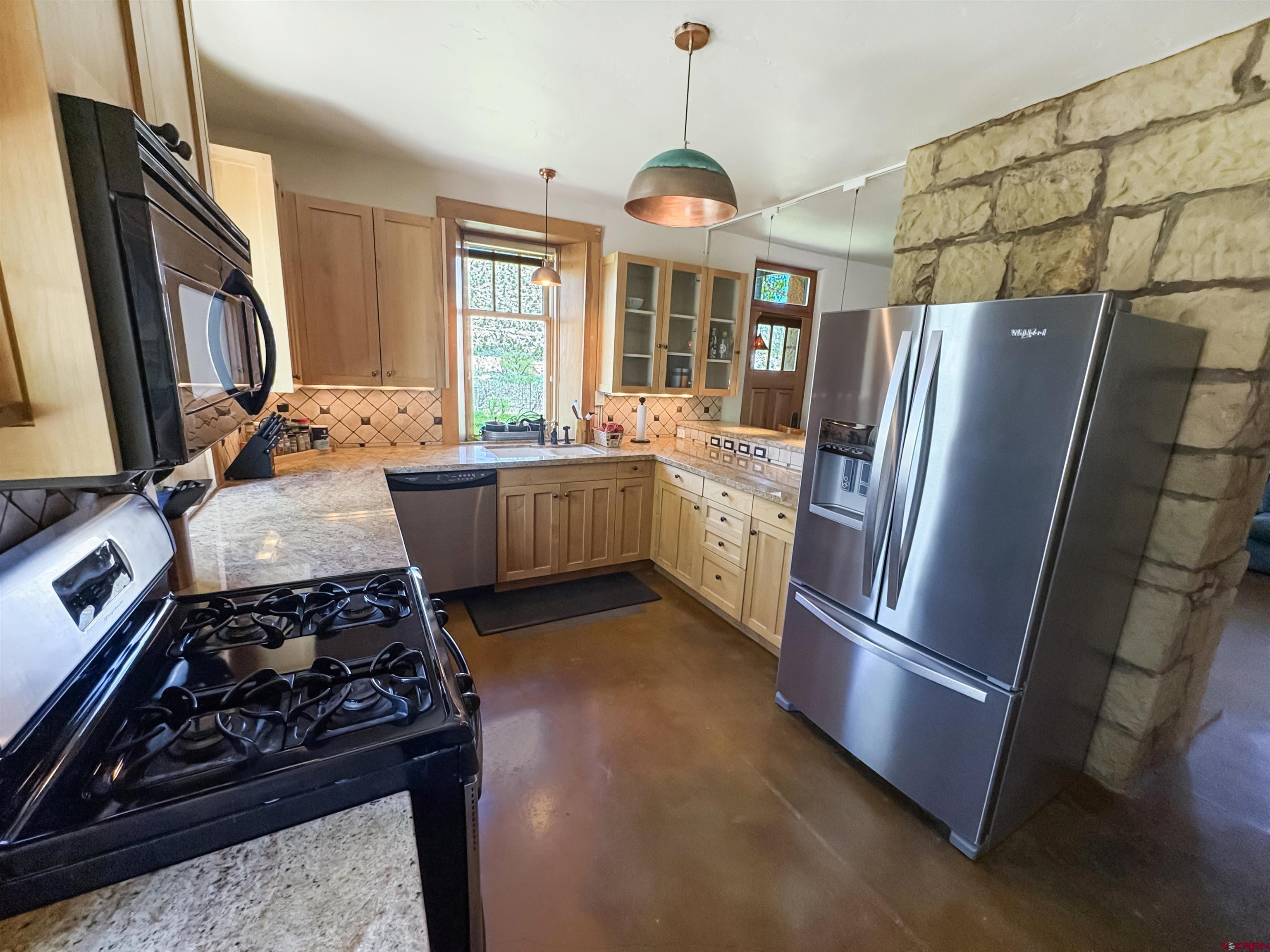 18261 Rd G Cortez, CO 81321 - Photo 14 of 45 a kitchen with stainless steel appliances granite countertop a refrigerator a stove and a sink