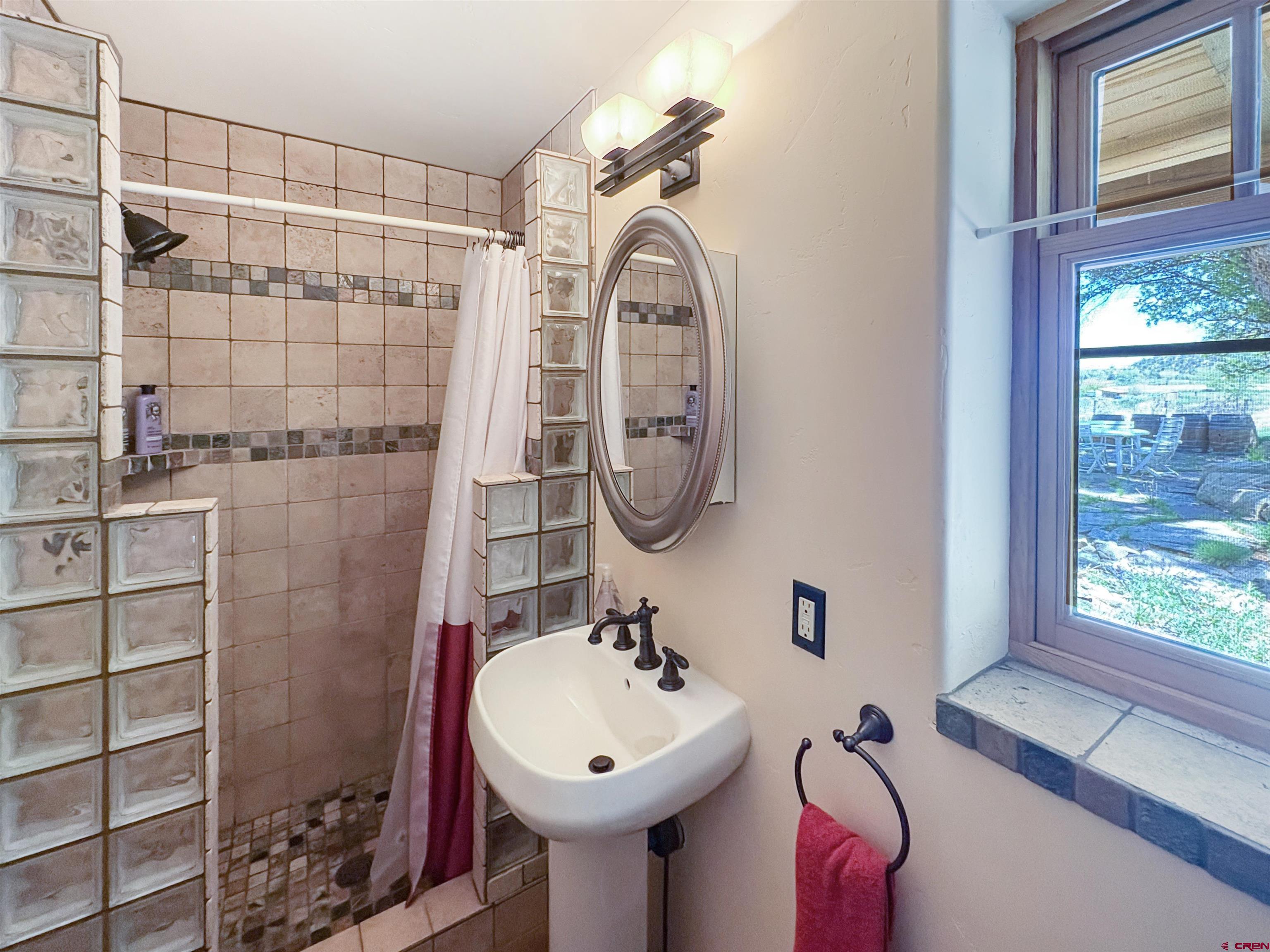 18261 Rd G Cortez, CO 81321 - Photo 17 of 44 a bathroom with a sink a toilet and shower