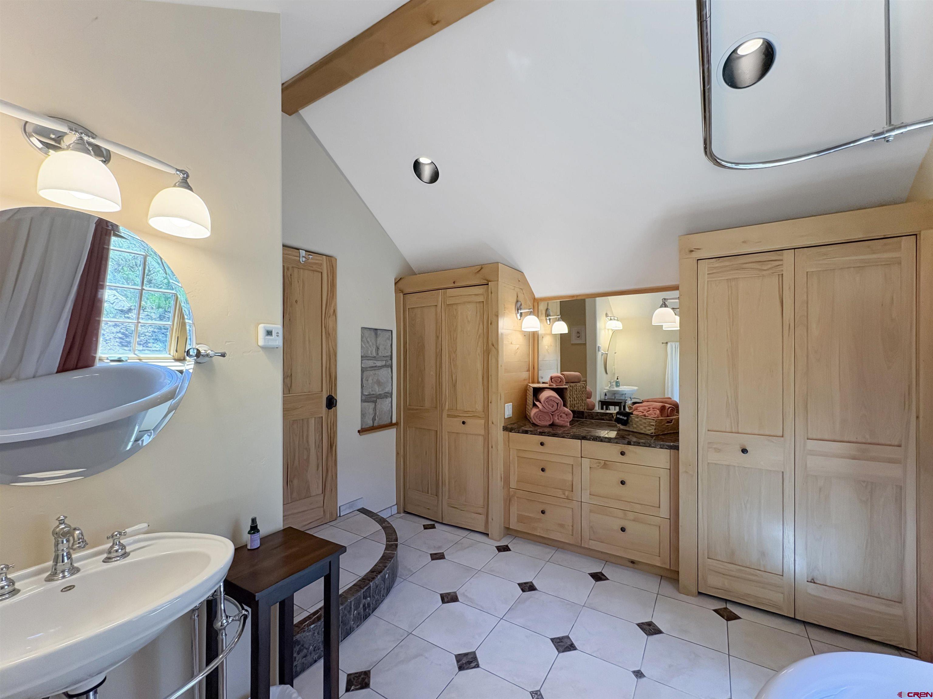 18261 Rd G Cortez, CO 81321 - Photo 23 of 45 a spacious bathroom with a double vanity sink a mirror and a shower