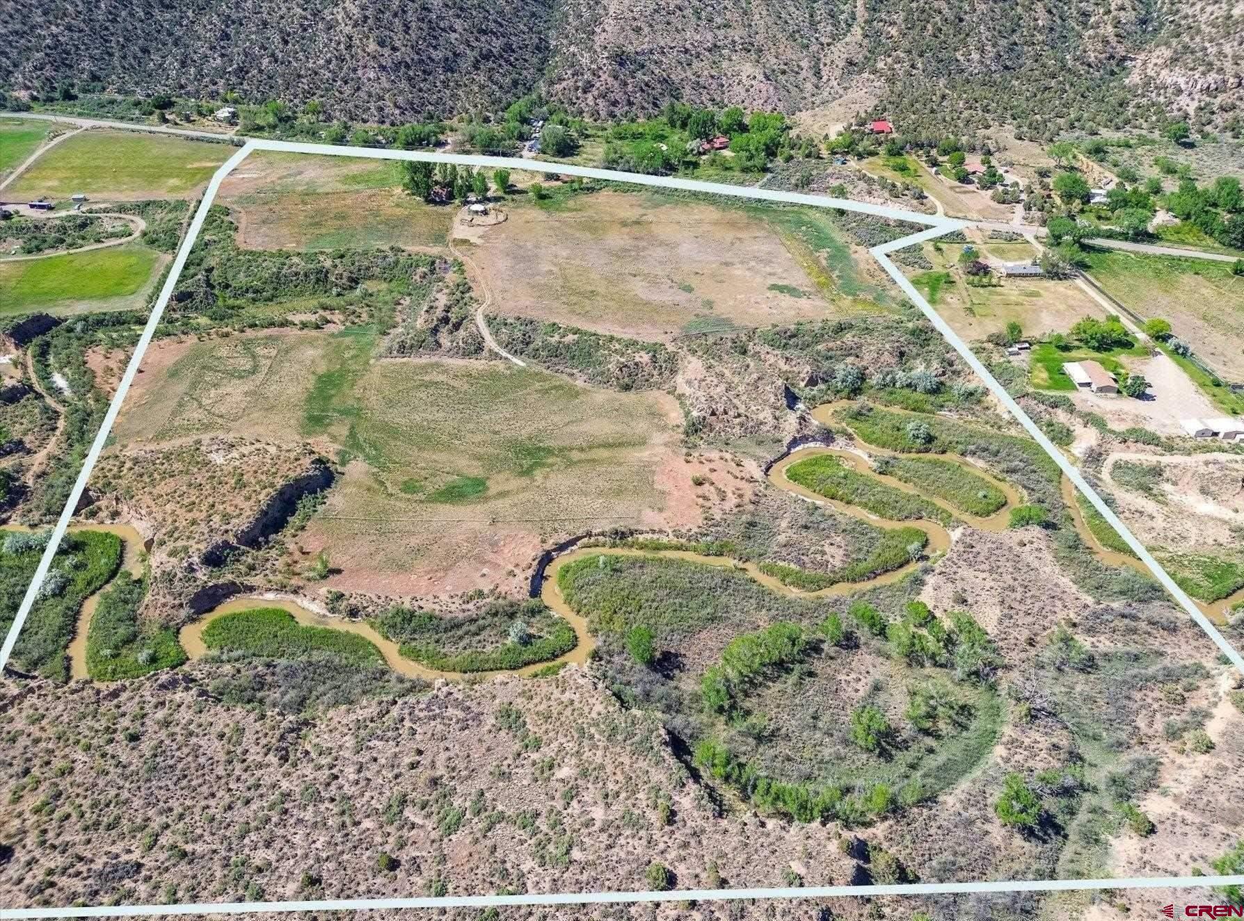 18261 Rd G Cortez, CO 81321 - Photo 32 of 44 a view of a backyard with plants and large lake view