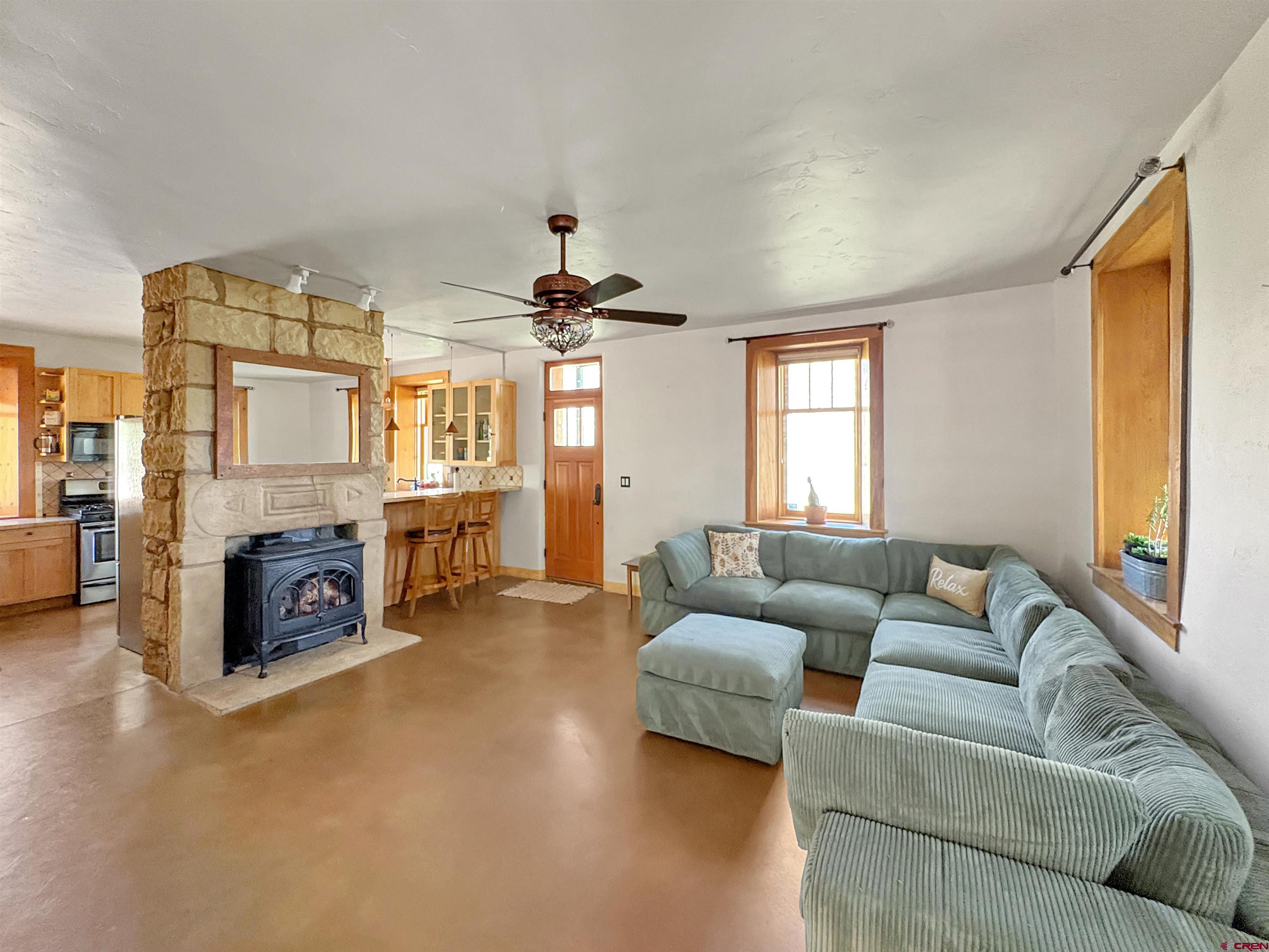 18261 Rd G Cortez, CO 81321 - Photo 9 of 45 a living room with furniture and a fireplace
