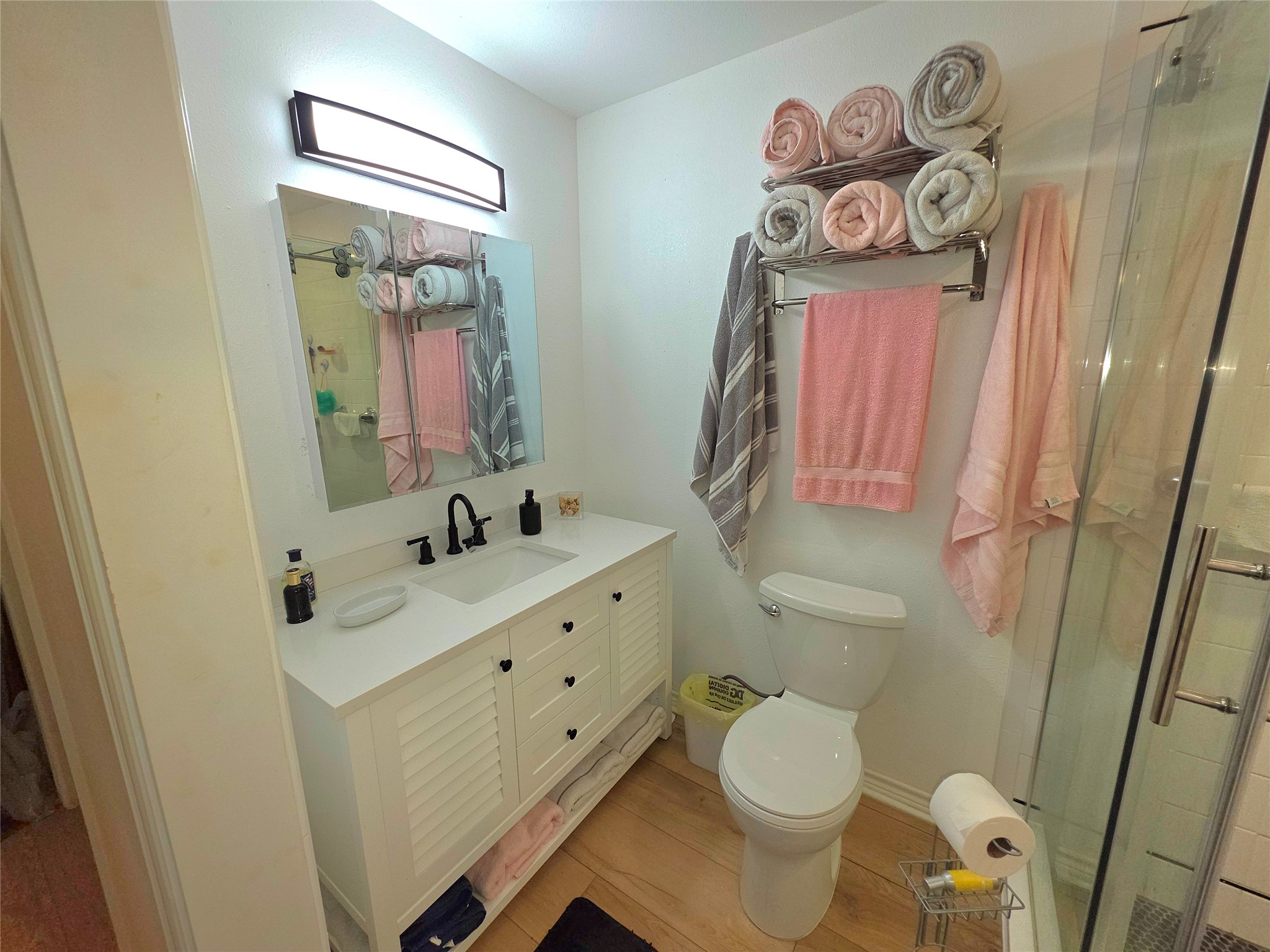 978 County Road 2859 Cleveland, TX 77327 - Photo 19 of 50 a bathroom with a sink a toilet and a mirror