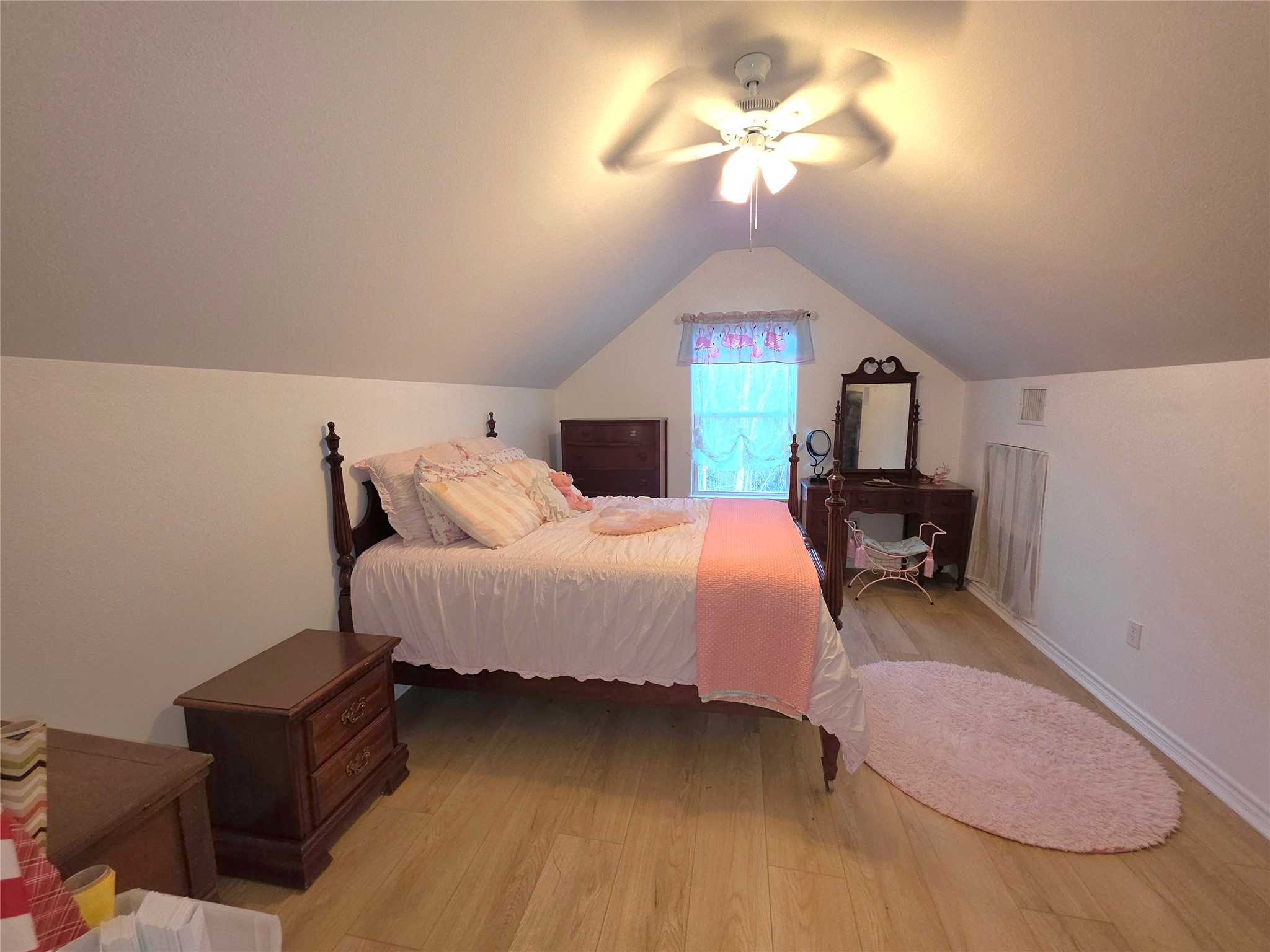 978 County Road 2859 Cleveland, TX 77327 - Photo 23 of 50 a bed room with a bed and a chandelier