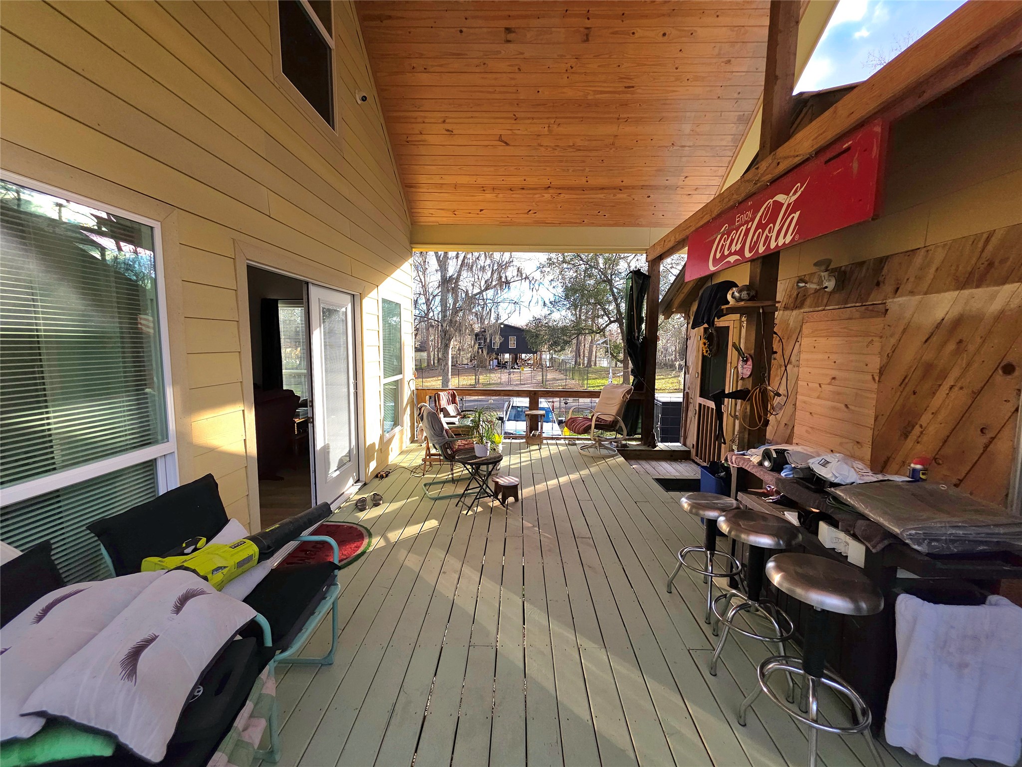 978 County Road 2859 Cleveland, TX 77327 - Photo 43 of 50 a view of a patio with table and chairs with wooden floor
