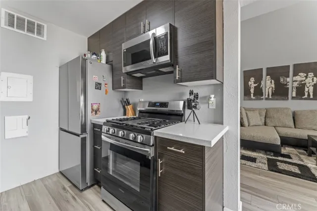 a kitchen with stainless steel appliances a stove a microwave and cabinets