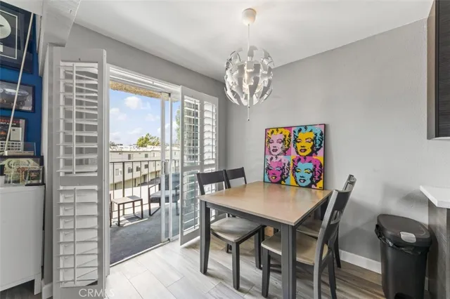 a view of a dining room with furniture a chandelier and wooden floor