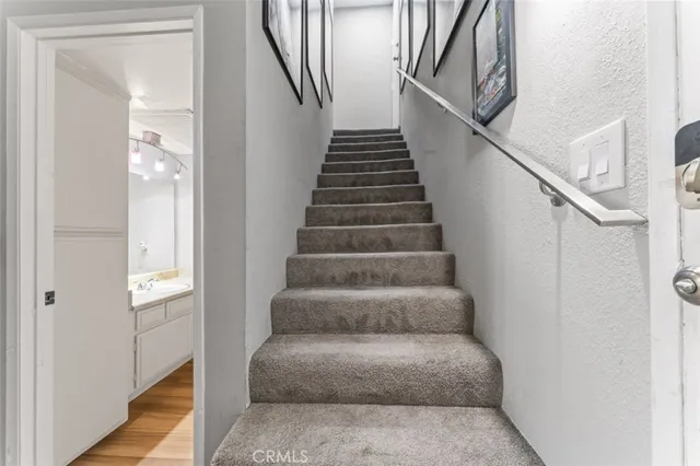 a view of staircase with white walls and a window