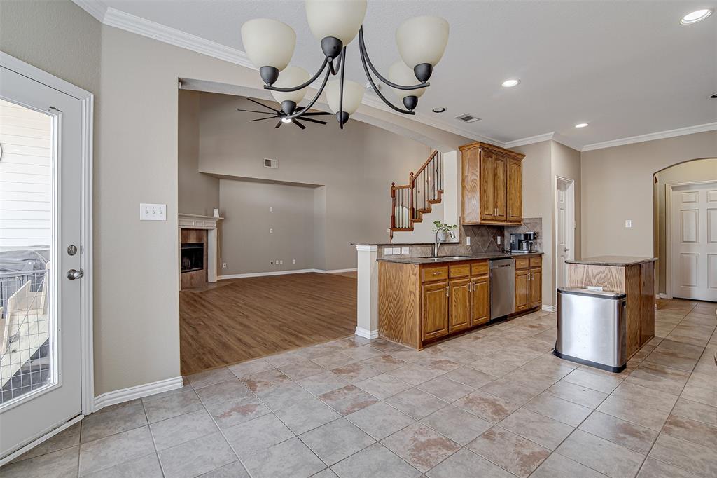 328 Tioga Street Burleson, TX 76028 - Photo 11 of 29 a kitchen with stainless steel appliances granite countertop a stove a sink dishwasher and a refrigerator with wooden floor
