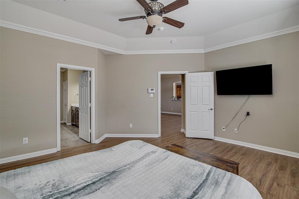 328 Tioga Street Burleson, TX 76028 - Photo 15 of 29 a bedroom with a bed and a flat screen tv