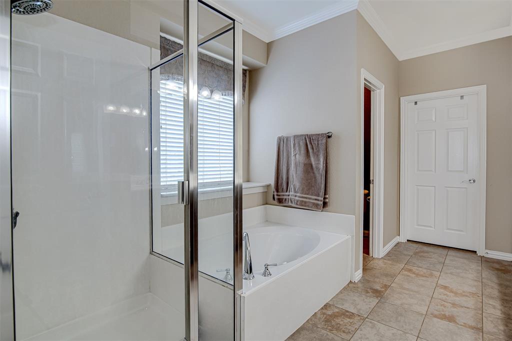 328 Tioga Street Burleson, TX 76028 - Photo 17 of 29 a bathroom with a tub and shower
