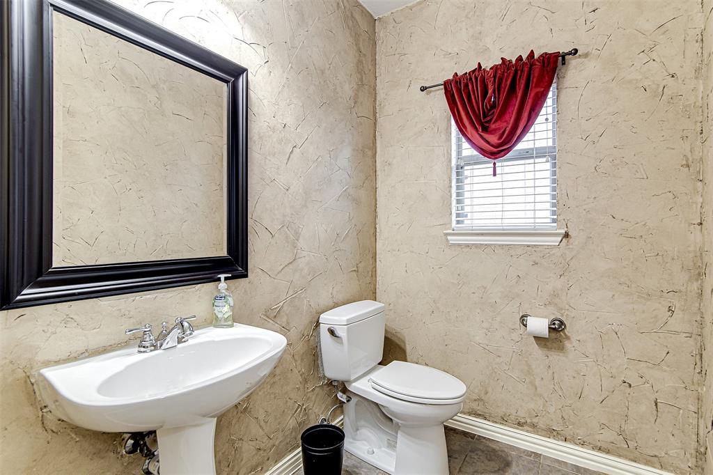 328 Tioga Street Burleson, TX 76028 - Photo 21 of 29 a bathroom with a sink and a mirror