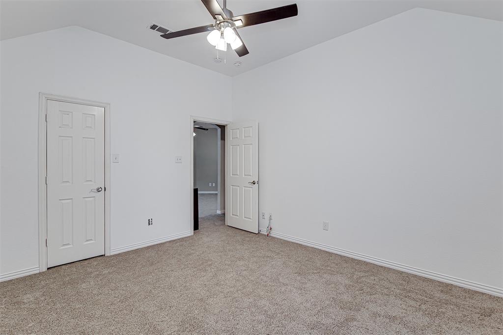 328 Tioga Street Burleson, TX 76028 - Photo 26 of 29 an empty room with a ceiling fan and closet area